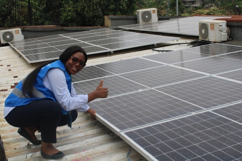 Woman in front of solar panels